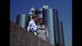 Wilma Deering and William "Buck" Rogers on an overlook from the top of a building, overseeing the expansive city of New Chicago (BR25: Film, "Awakening").