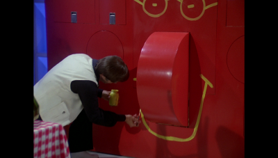 William "Buck" Rogers's adds a personalized flourish to the "dining monolith"[1] in his 25th century accommodations, finishing off the art piece with a smile (BR25: "Awakening").