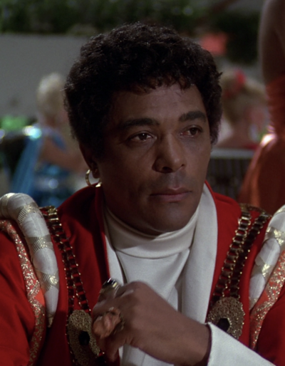 Julio at the celebratory banquet following Regis Saroyan's return to Vistula (BR25: "Planet of the Slave Girls").