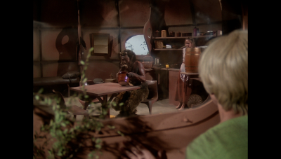 Delph Samos watches in horror from outside their hut as Pangor terrorizes his mother, Cyra Samos, on the planet Arkadis in an episode airing this day on 12 March 1981 CE (BR25: "The Satyr").