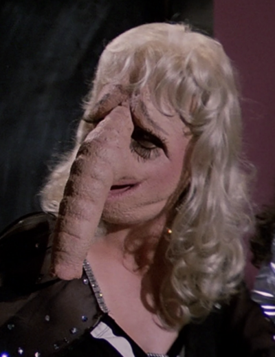 A feminine-looking Trunk-nosed Humanoid that William "Buck" Rogers hits on, believing her to be a human before she turns around to face him (BR25: "The Plot to Kill a City, Part I").
