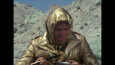 Maj. Duke Danton attempts to eat some meat taken from a creature William "Buck" Rogers killed in Vistula's Sea of Stone (BR25: "Planet of the Slave Girls").