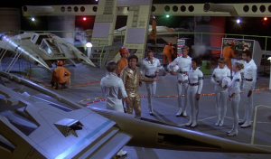 Dr. Elias Huer presents the only active pilots available for the Battle of Vistula (BR25: "Planet of the Slave Girls").