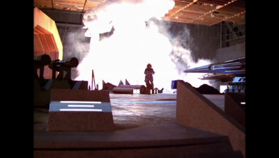 An explosion in Draconia's launch bay illuminates the blackened walls of the soundstage (BR25: Film, "Awakening"). See: Continuity errors#Awakening for more.