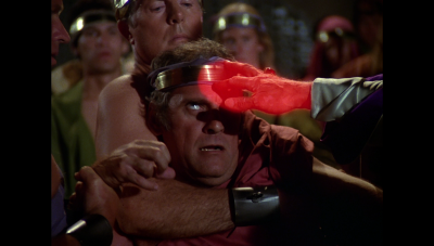 Kaleel demonstrates the "Touch of Truth" against a fearful unbeliever, after being outed by his own wife (BR25: "Planet of the Slave Girls").