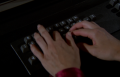 [Photo 3]: An insert shot of Wilma Deering typing at a keyboard, of note are the sleeves to her red jumpsuit, which she is not wearing in this scene (BR25: "Planet of the Slave Girls").