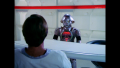 [Photo 1A]: William "Buck" Rogers, Theopolis and Twiki present at Rogers' first debriefing; Theo asks Twiki to put him down to look at Rogers, so that Twiki may get Rogers a refreshment (BR25: Film, "Awakening").